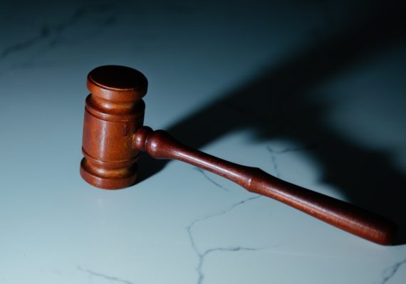 a wooden judge's hammer sitting on top of a table