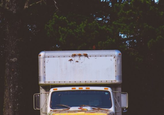 closeup photo of white and yellow box truck