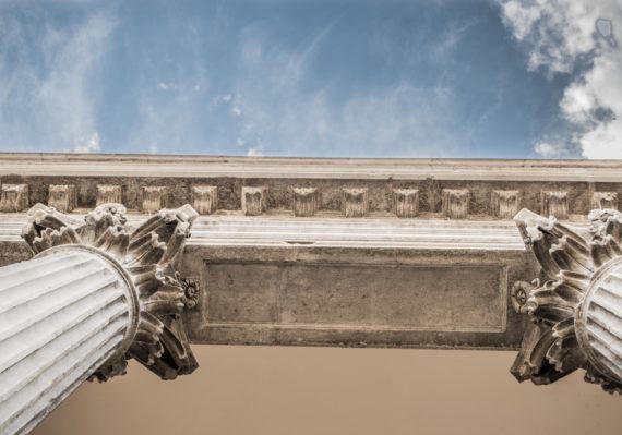 worm eye view of white concrete pillar during day time