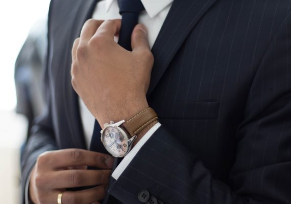 man wearing watch with black suit