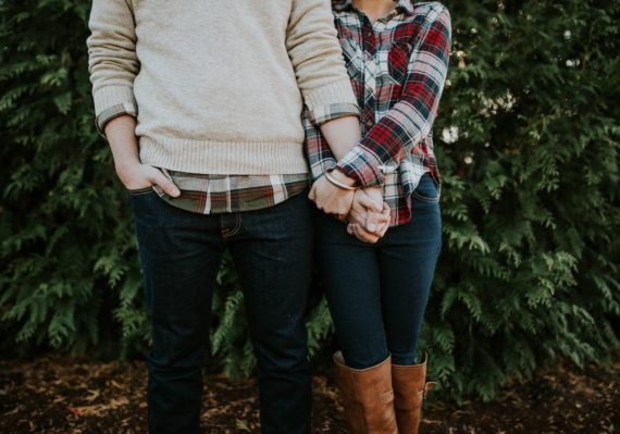 woman holding man hand