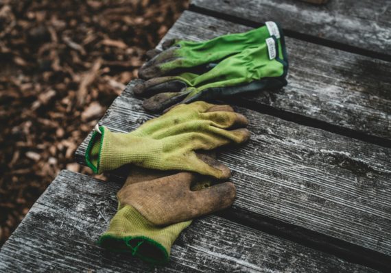 brown and green sock on gray wooden surface
