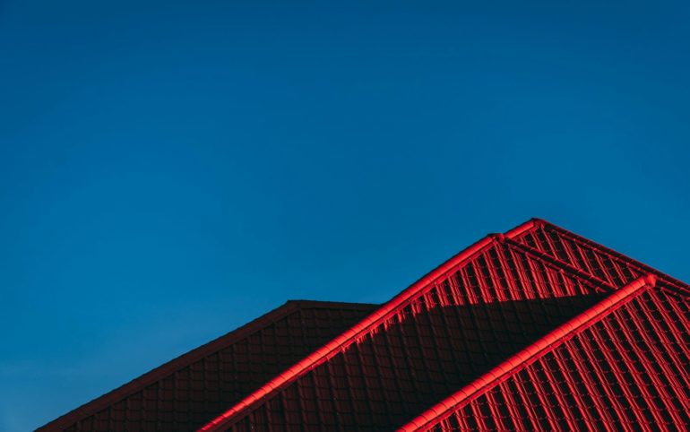 red and black building under blue sky